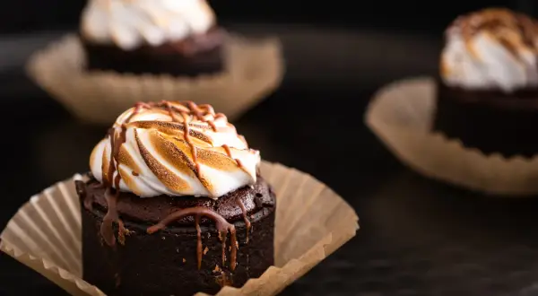Pyszne babeczki brownie z pianką marshmallow i polewą czekoladową, idealne na deser.