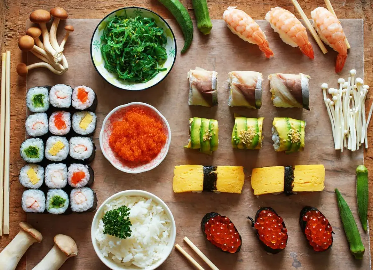 Pyszne sushi: rolki z łososiem, awokado, krewetkami, tamago, ikrą, ryżem i sałatką wakame. Idealne na co do sushi.